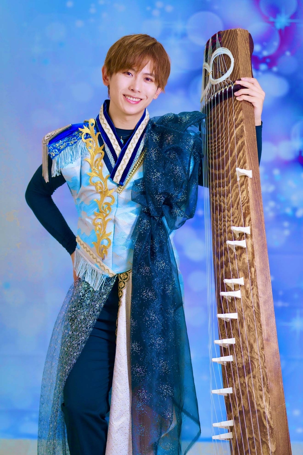 Yoshiaki OKAWA aguantando con la mano el arpa japonesa koto, puesta en vertical